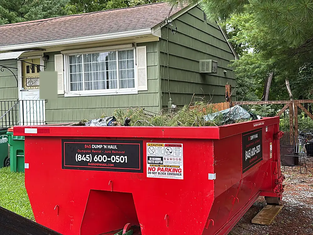 10-yard dumpster loaded with brush and yard waste in Hyde Park, NY — 845 Dump 'N Haul
