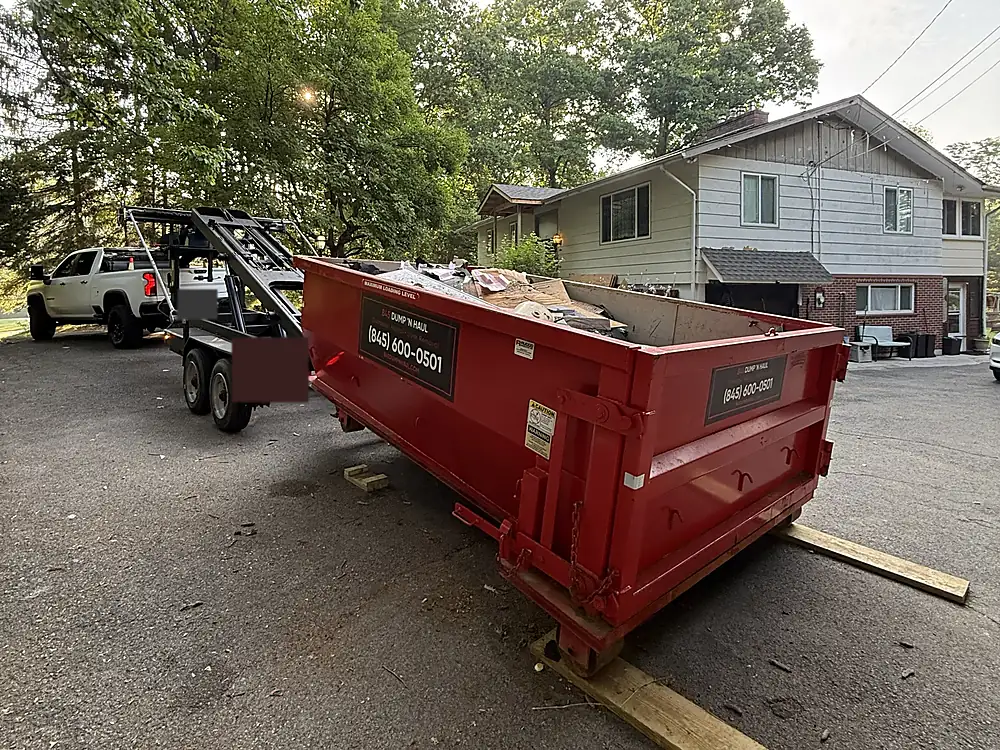 Roll-off dumpster being delivered on protection boards — 845 Dump 'N Haul, Dutchess County NY