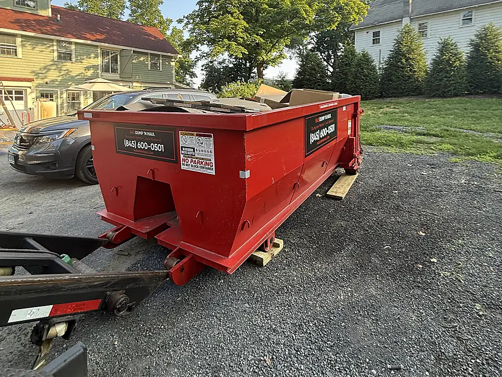 Dumpster set on a gravel driveway at an older home in Hyde Park, NY — 845 Dump 'N Haul