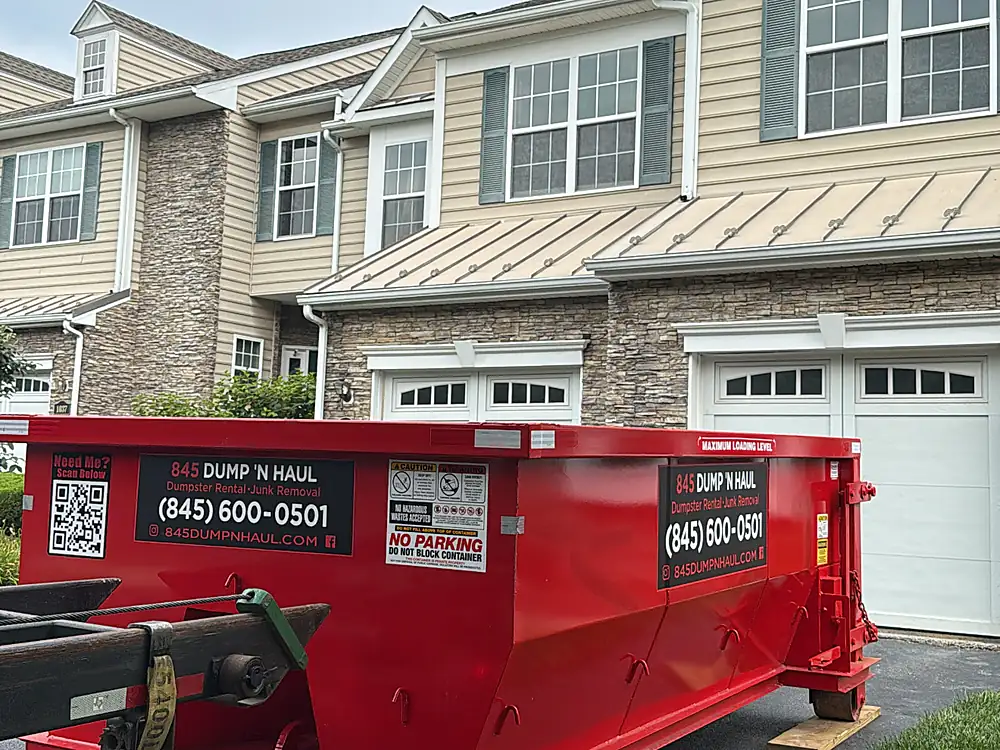 Red roll-off dumpster at a townhouse community in Poughkeepsie, NY — 845 Dump 'N Haul