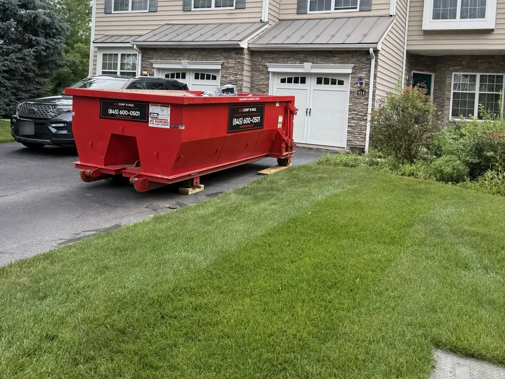 Dumpster positioned at the garage for an easy cleanout in Newburgh, NY — 845 Dump 'N Haul