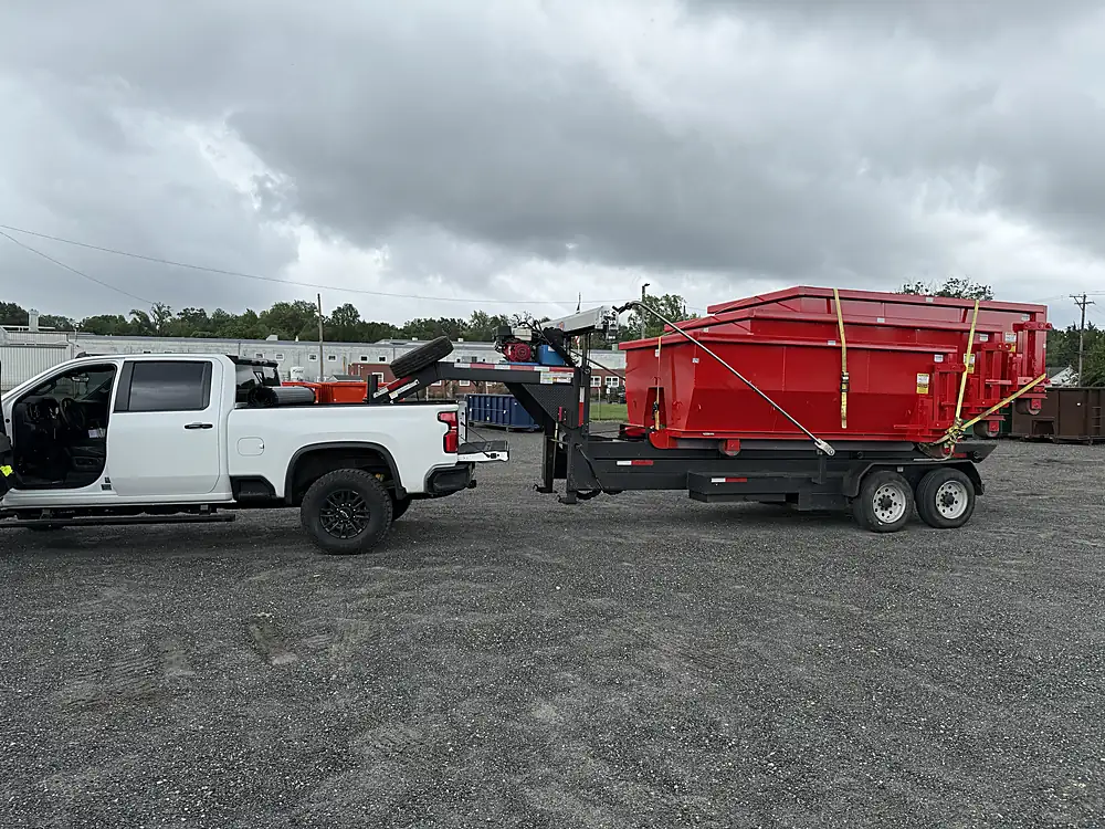 Service truck and gooseneck trailer hauling a roll-off container in Rhinebeck, NY — 845 Dump 'N Haul